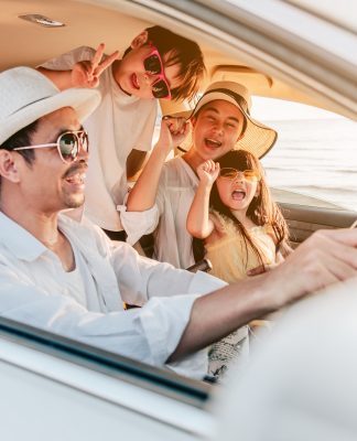 Portrait,Of,Family,Enjoying,Beach,Trip,With,Their,Favorite,Car.