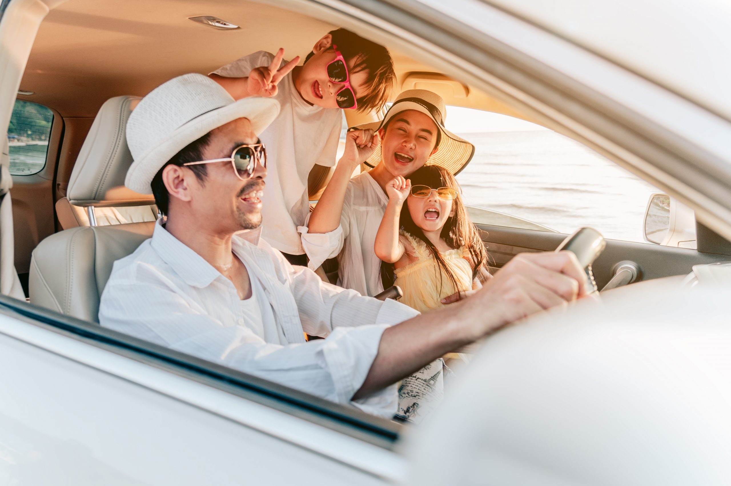 Portrait,Of,Family,Enjoying,Beach,Trip,With,Their,Favorite,Car.