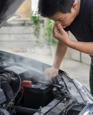 Aki Mobil Sudah Harus Diganti: 10 Tanda yang Sering Diabaikan Mekanik memeriksa aki mobil yang lemah di bengkel, menunjukkan tanda-tanda aki harus diganti